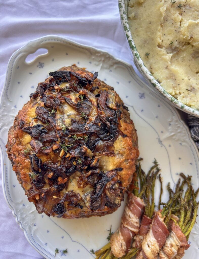 Baked French onion meatloaf with golden melted Gruyère and caramelized onion topping