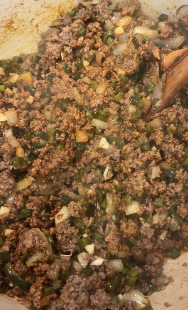 Okie Rub and tomato paste added to ground bison and fresh peppers to build the flavor base for spicy bison chili