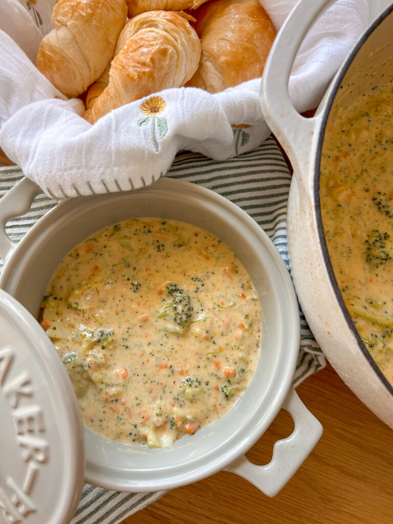 Creamy broccoli cheddar soup with tender broccoli and carrots served in a bowl