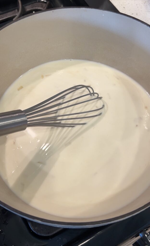 Chicken broth and half-and-half whisked into the roux for broccoli cheddar soup
