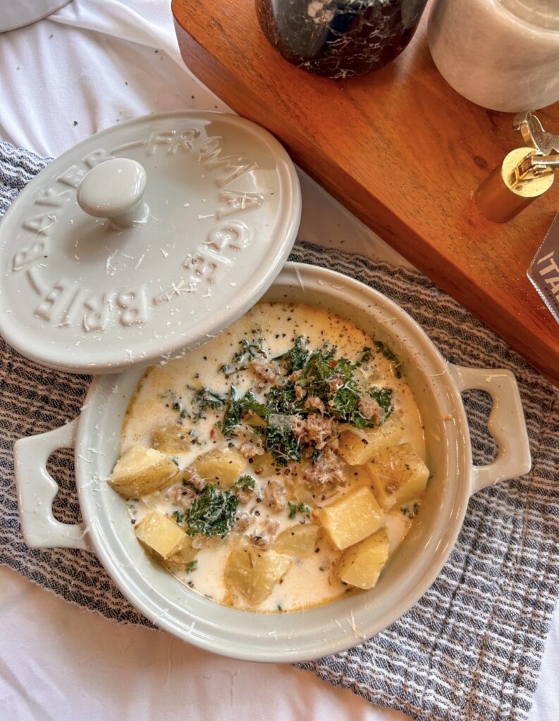 Heavy cream stirred into Olive Garden Zuppa Toscana with sausage, potatoes, and kale