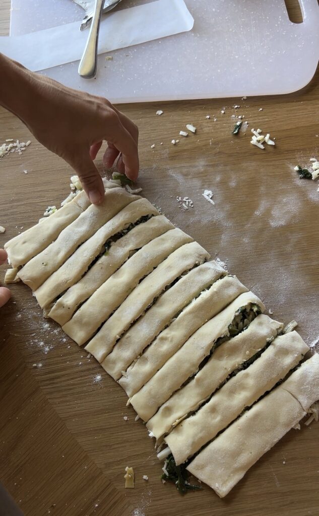 Filled puff pastry folded and cut into even strips