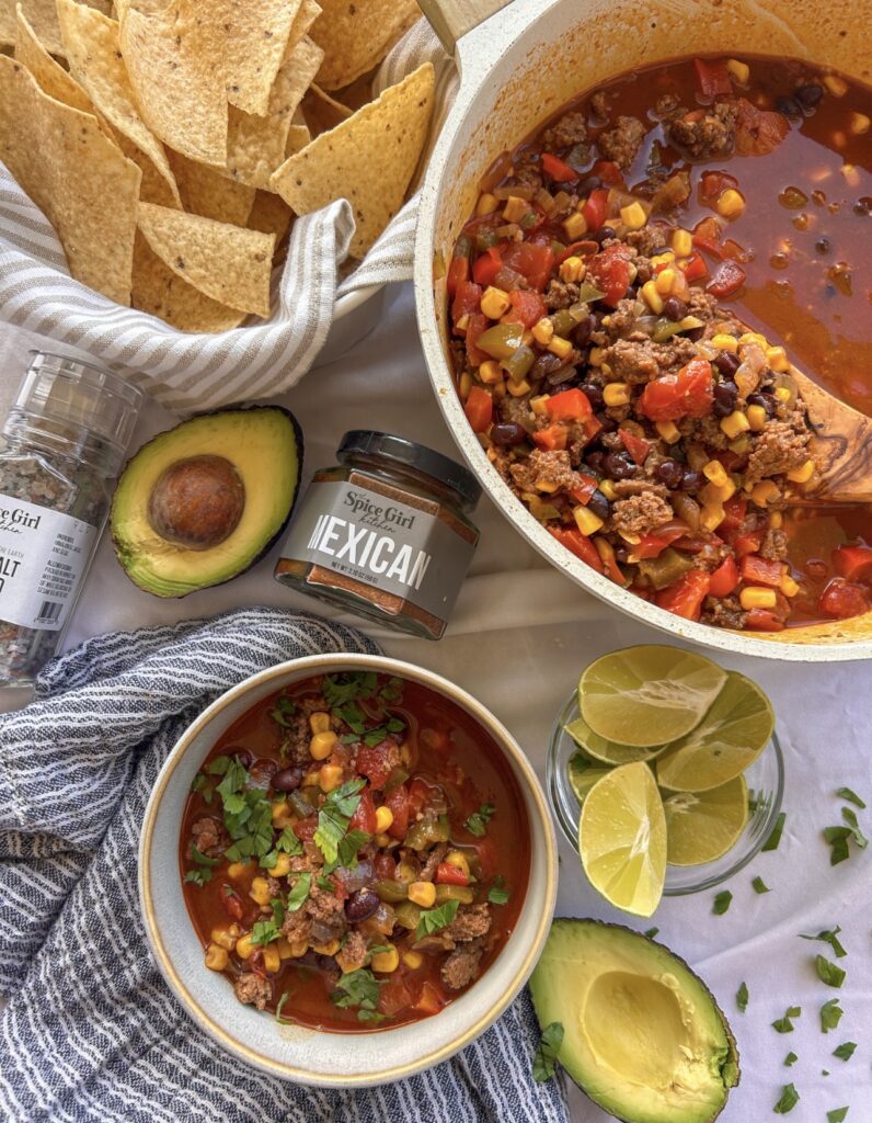 Easy one pot taco soup topped with cheese, sour cream, avocado, cilantro, and tortilla chips