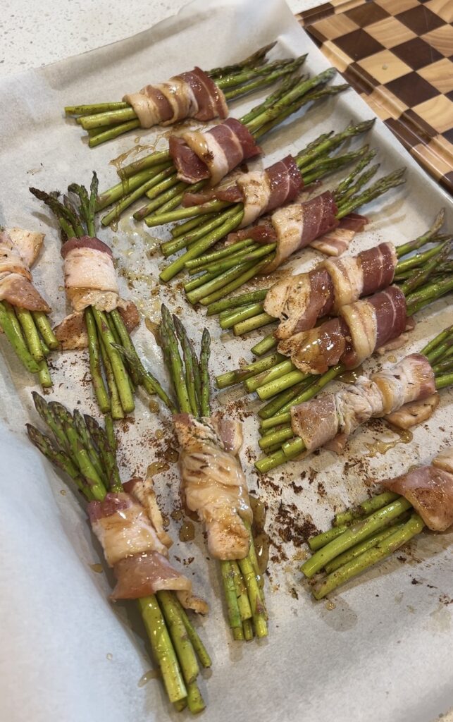 Bacon wrapped asparagus brushed with brown sugar and hot honey glaze before baking