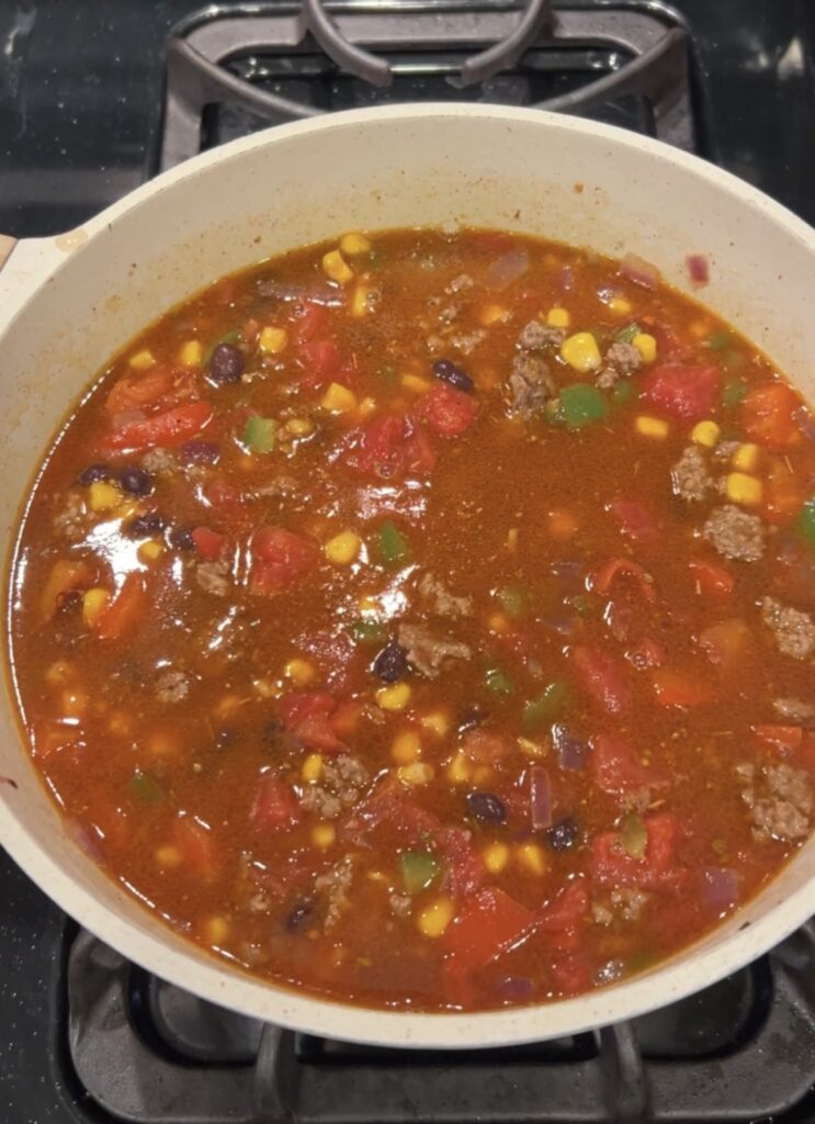 Black beans, corn, diced tomatoes, beef broth, and Mexican seasoning added to taco soup