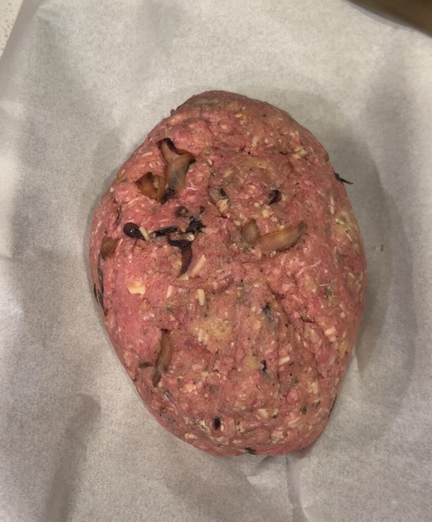 French onion meatloaf mixture shaped into a free-form loaf on a baking sheet