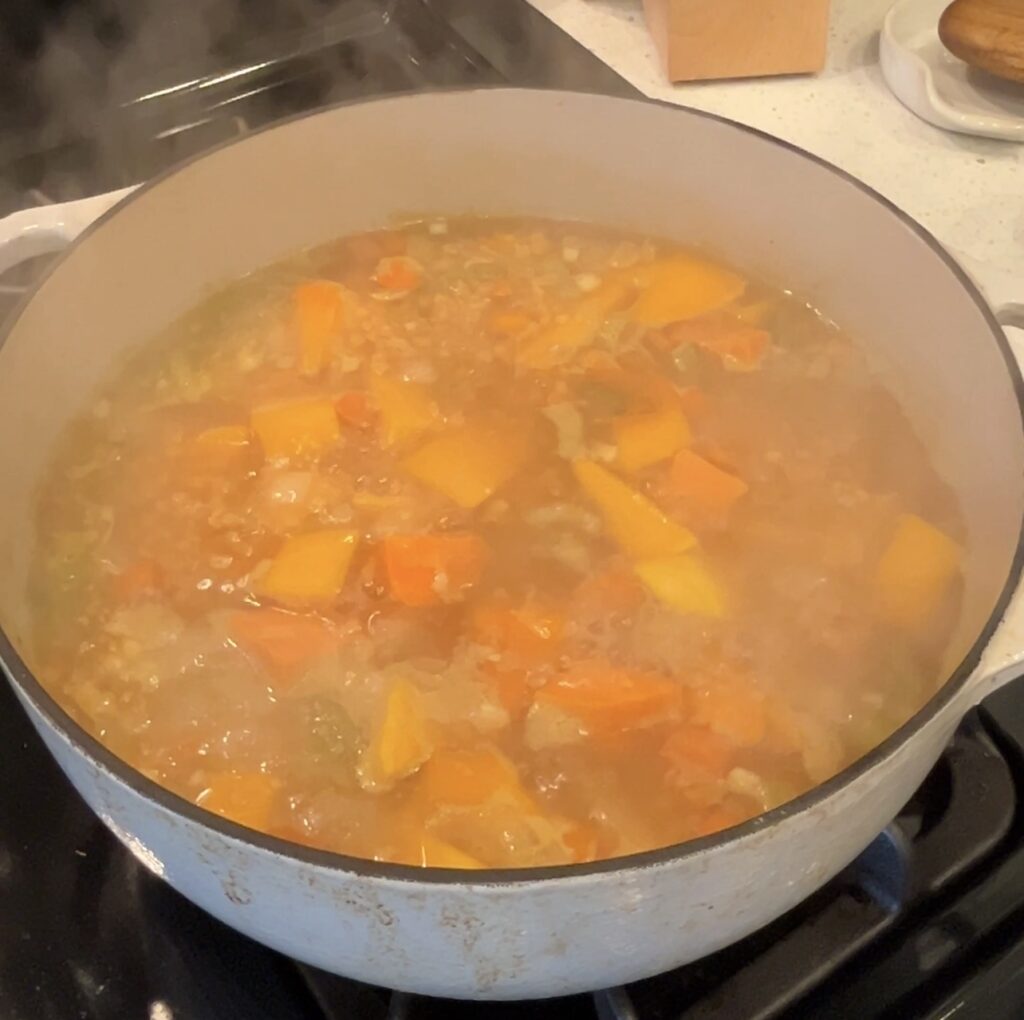 Butternut squash red lentils and sweet potato simmering in vegetable broth