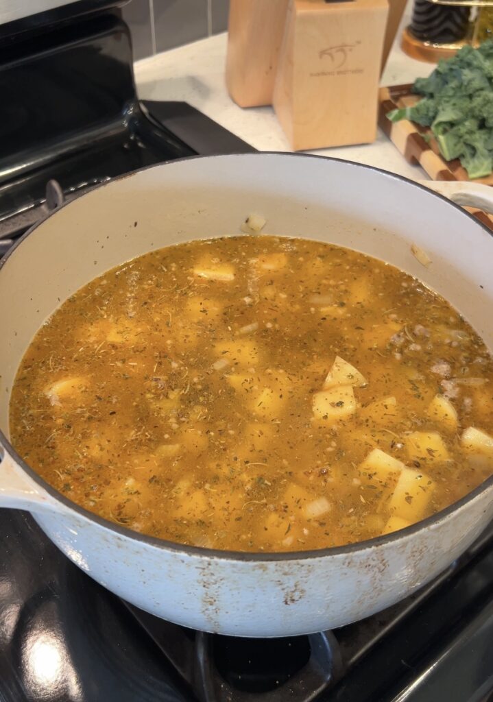 Yukon Gold potatoes simmering in chicken broth for homemade Zuppa Toscana