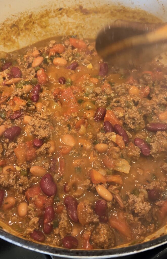 Thick spicy bison chili with ground bison, beans, and fire-roasted tomatoes after simmering