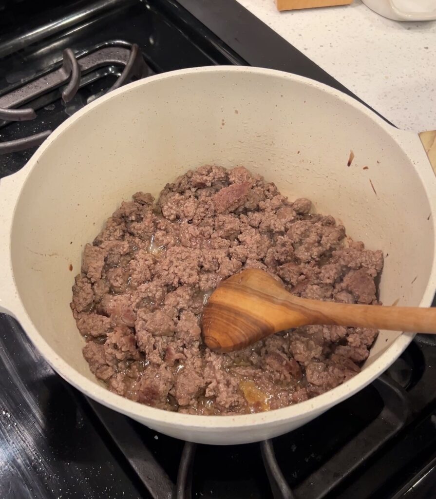 Ground beef browning in a Dutch oven for taco soup