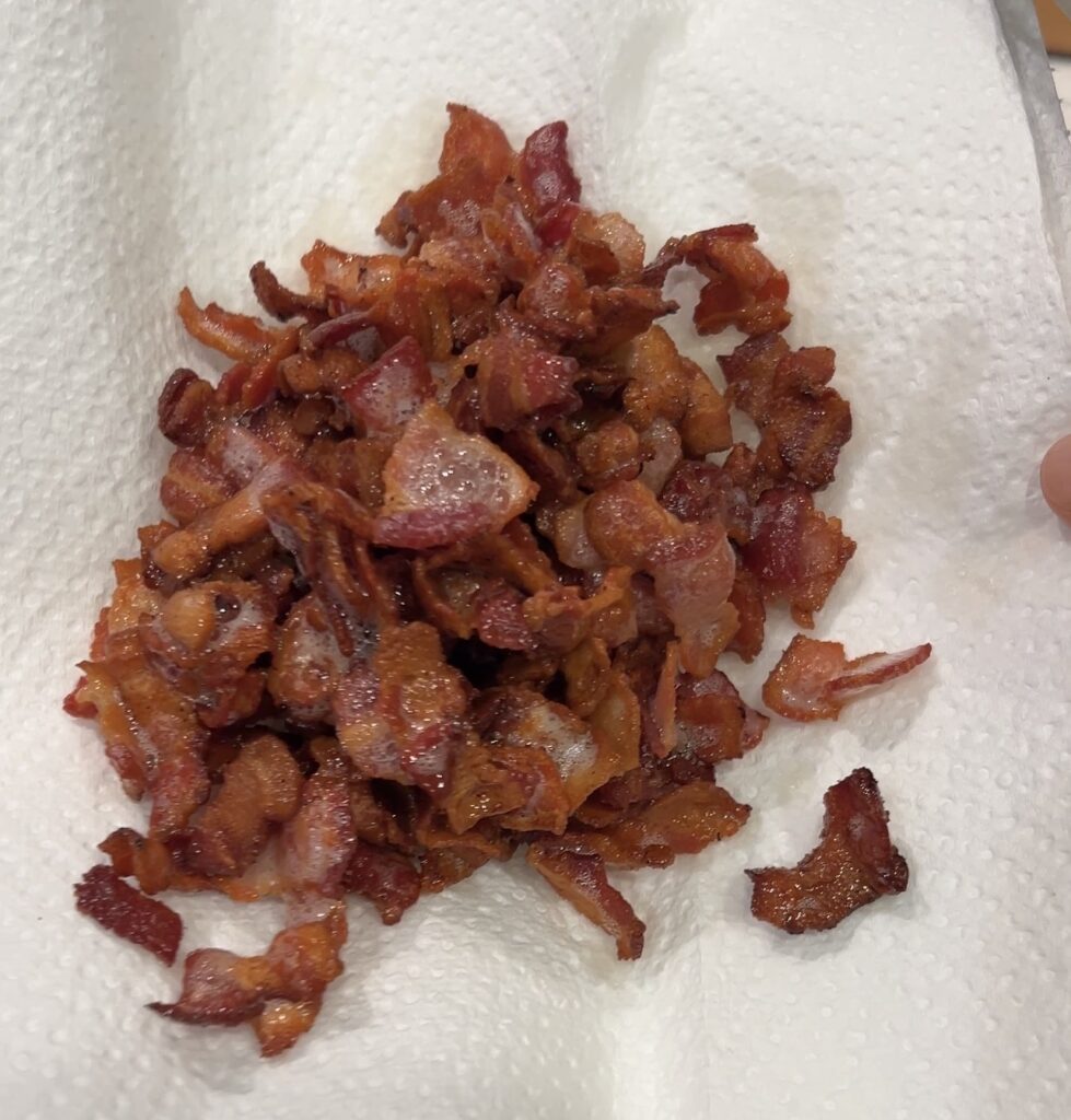 Crispy bacon cooking in a Dutch oven for loaded potato soup