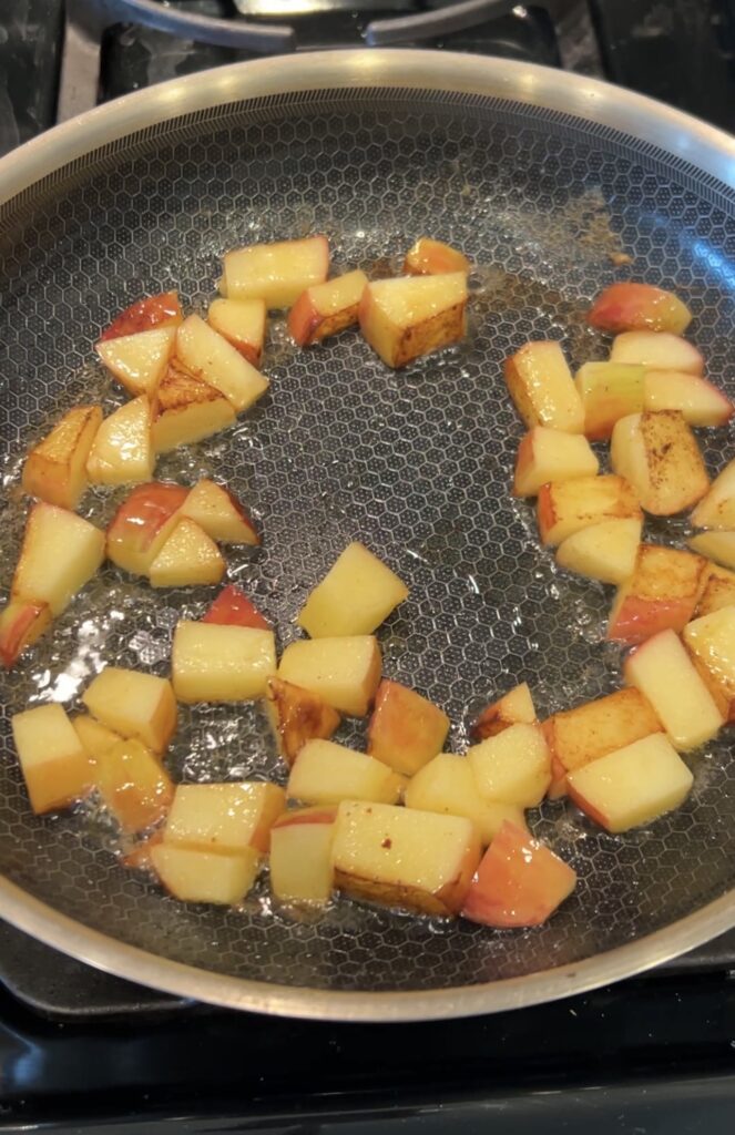 Diced Honeycrisp apples browning in butter in a skillet