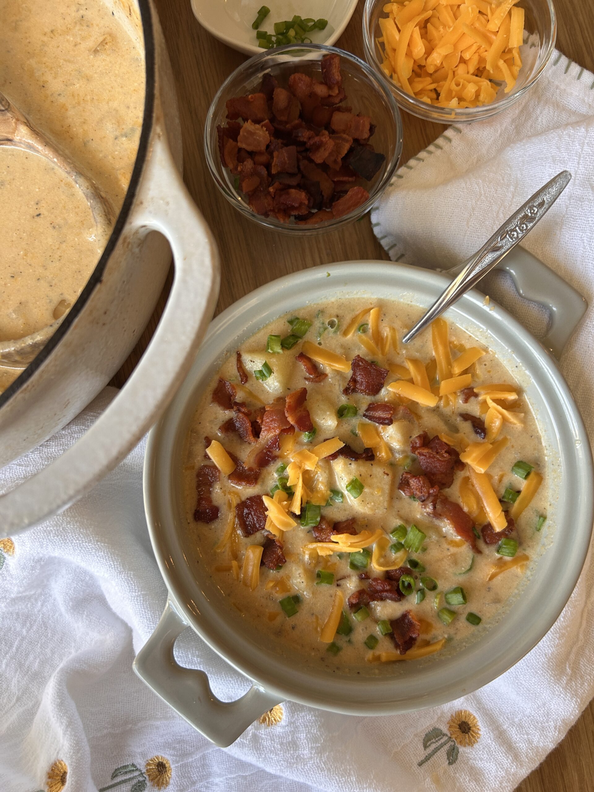 Loaded baked potato soup topped with bacon, cheddar, sour cream and green onions