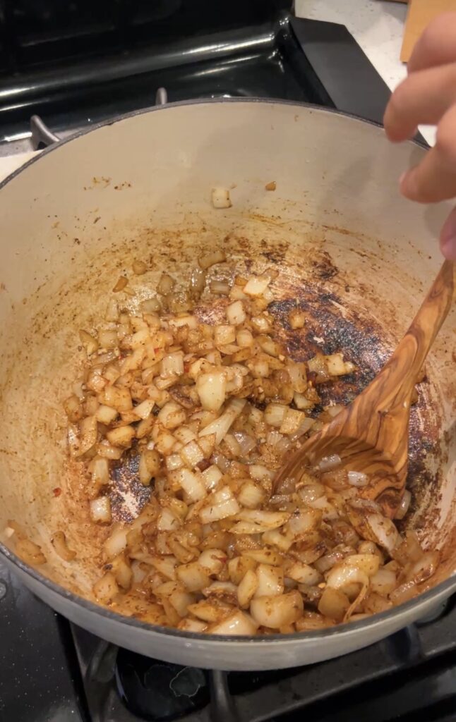 Onion, garlic and Okie Rub cooking in bacon drippings