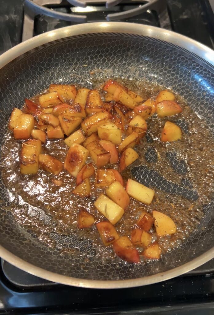 Caramelized apples coated with maple syrup, brown sugar, Dijon, and French herbs