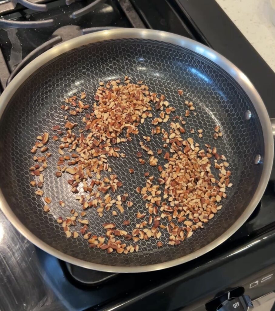 Chopped pecans toasting in a dry skillet
