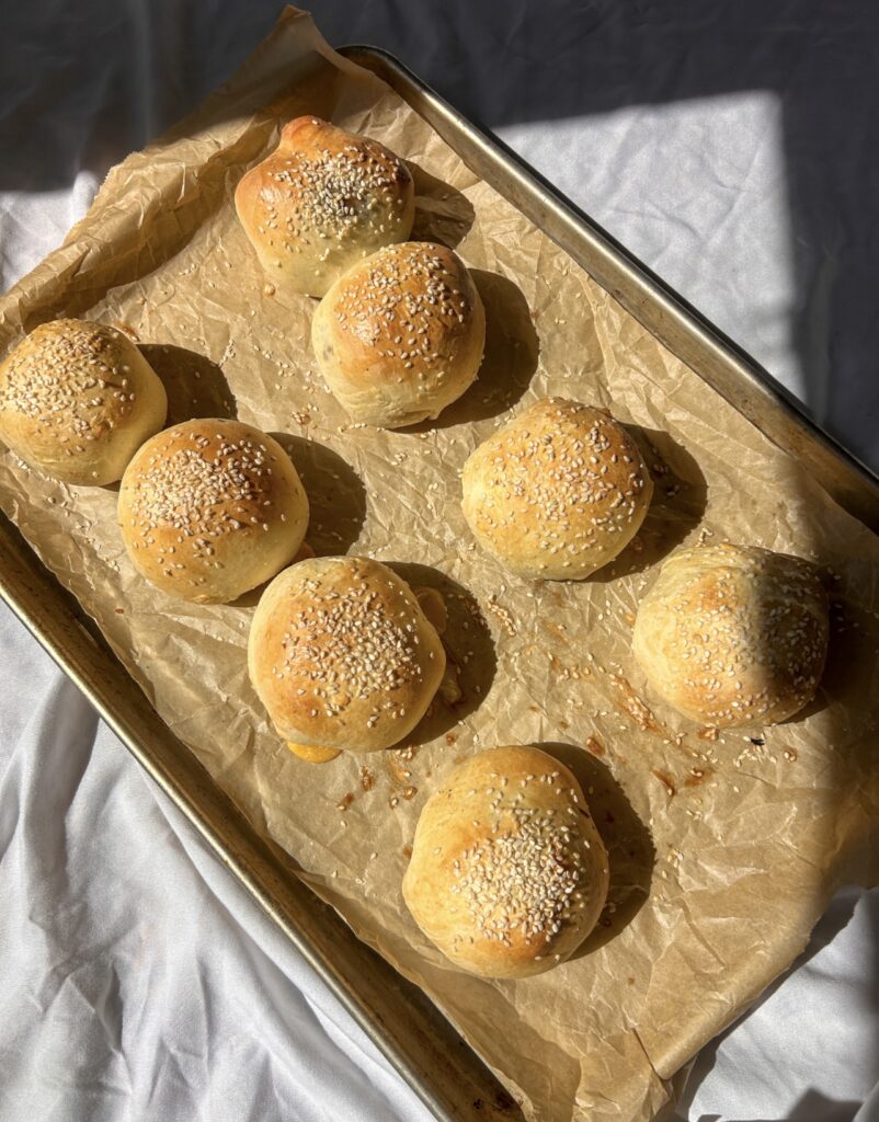 Golden sesame-topped cheeseburger bombs fresh from the oven