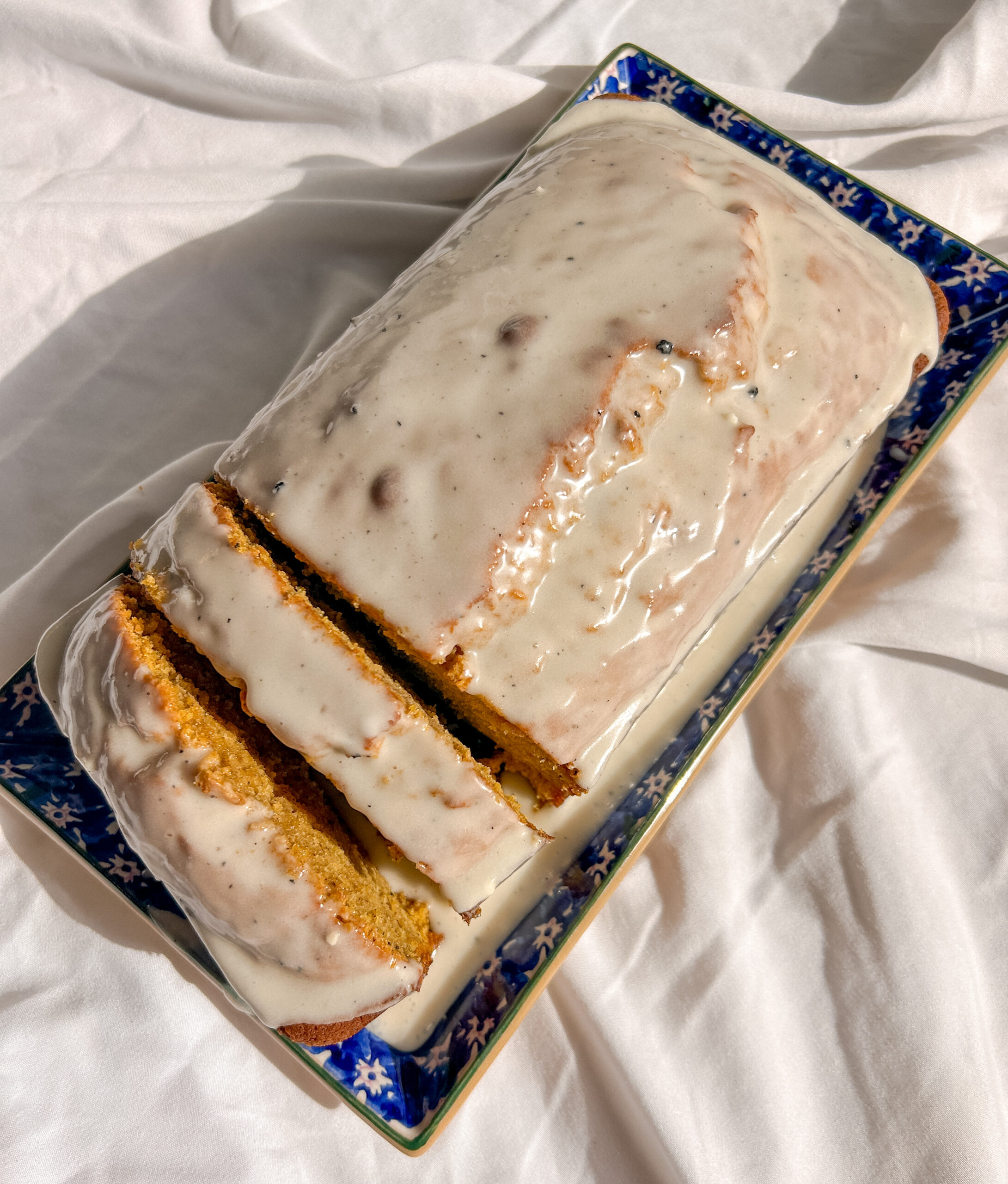 Homemade brown butter pumpkin bread topped with a thick maple bourbon glaze.
