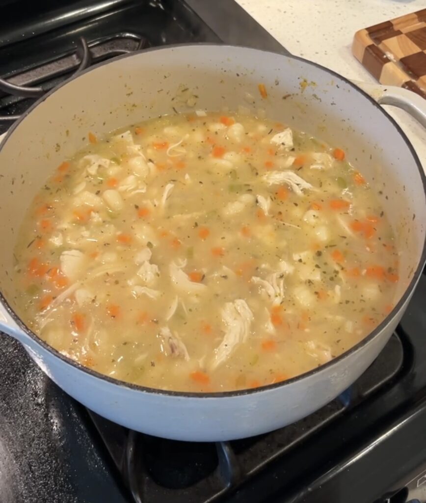 Potato gnocchi cooking in the savory soup broth.