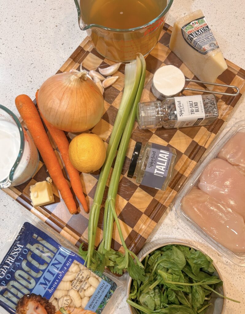 Ingredients for chicken gnocchi soup, including chicken breasts, potato gnocchi, vegetables, half-and-half, Parmesan, and Italian seasoning.