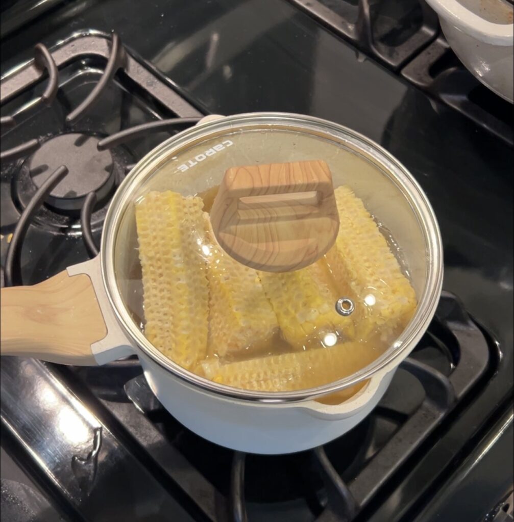 Corn cobs simmering in stock to make corn broth for the bisque.