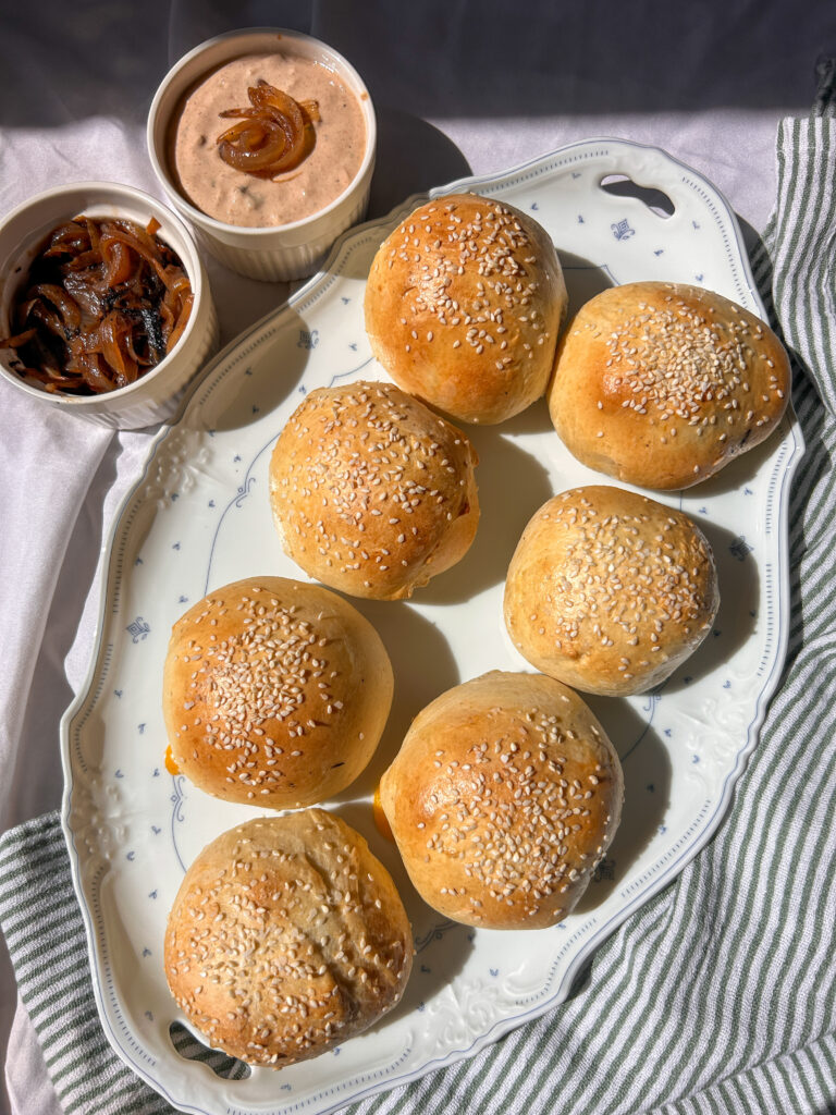 Homemade cheeseburger bombs filled with seasoned beef, cheese, caramelized onions and pickles