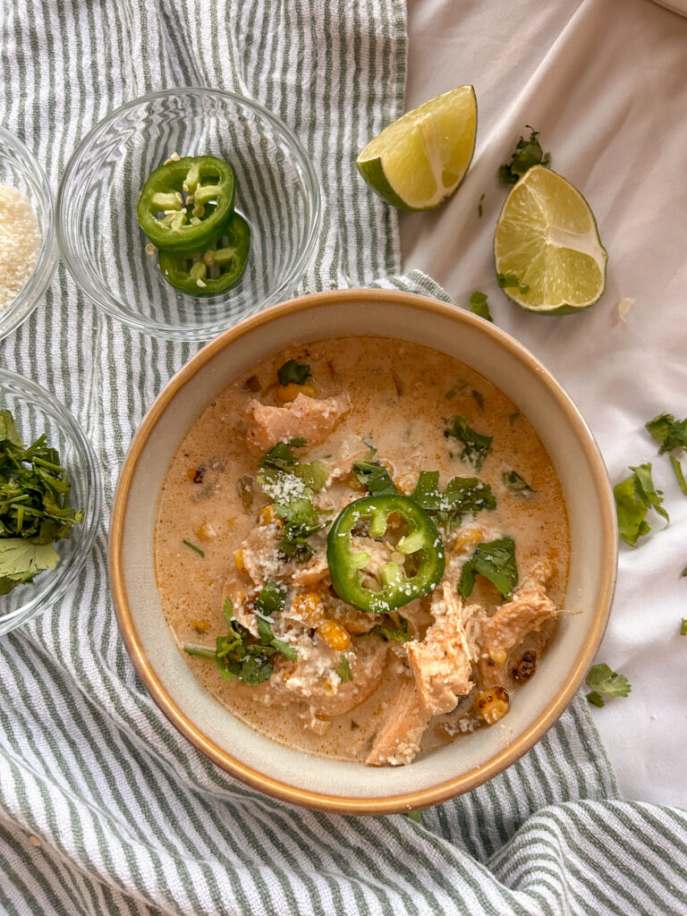 Creamy Mexican street corn soup with shredded chicken, corn, cotija cheese, and cilantro.
