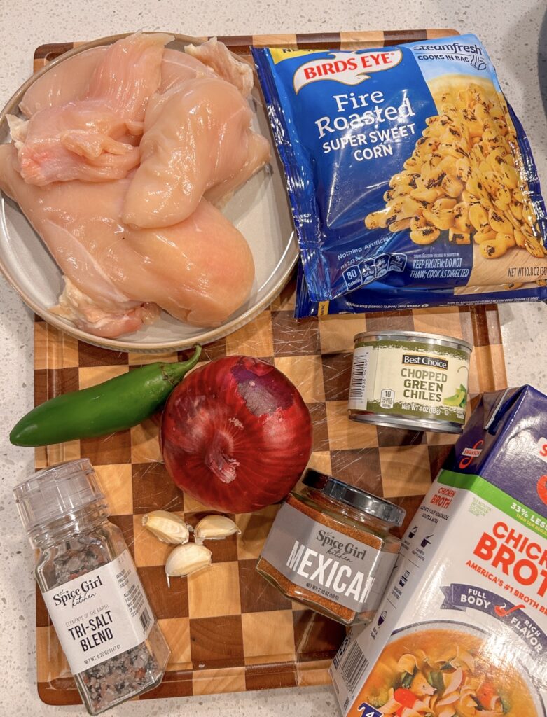 Chicken breasts, corn, green chiles, red onion, jalapeño, garlic, broth, and seasonings for Mexican street corn soup.