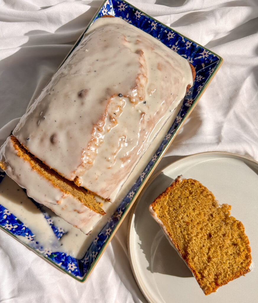 Sliced brown butter pumpkin bread showing its soft, moist interior and maple bourbon glaze.