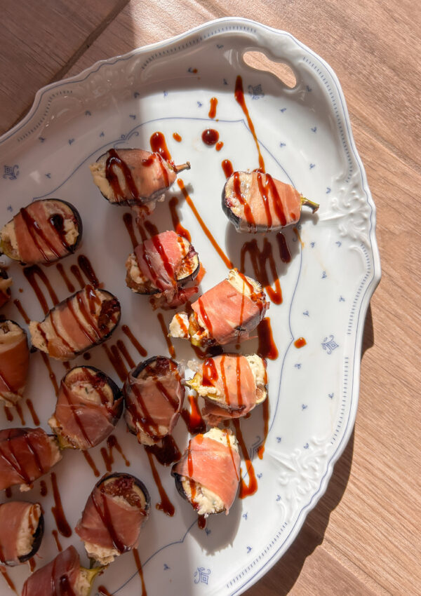 Prosciutto wrapped figs stuffed with creamy Boursin cheese and drizzled with balsamic glaze.