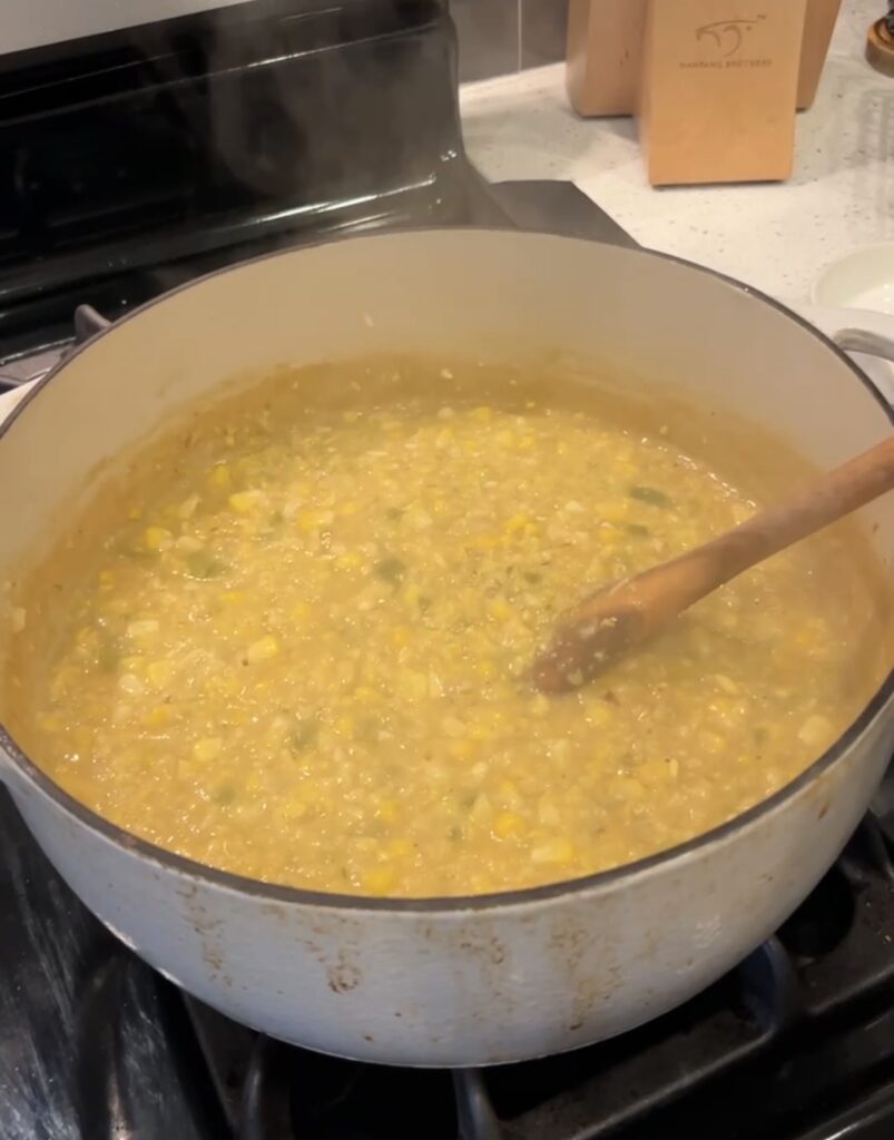 Corn bisque partially blended for a creamy base with whole corn kernels.