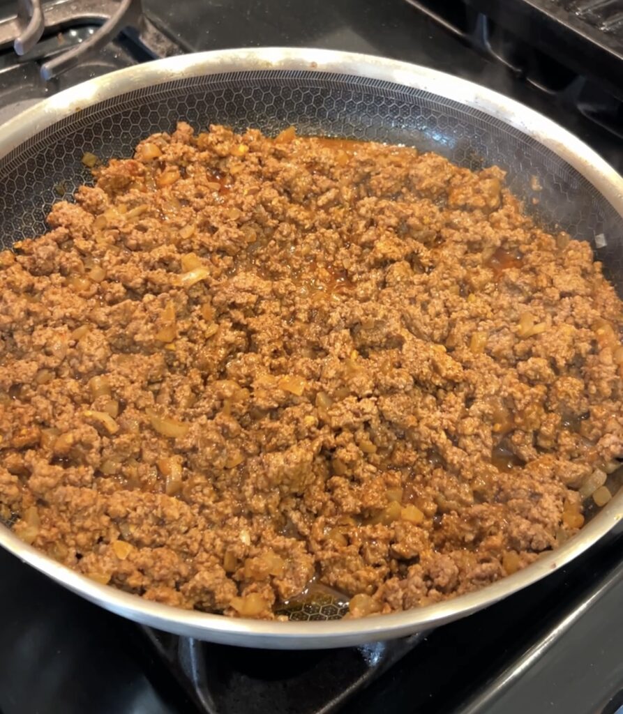 Taco-seasoned ground beef simmering with tomato paste and Mexican spices until thick and saucy.